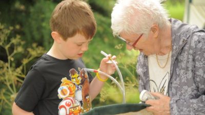 child and adult with an insect pooter, collecting tube and sweep net. Credit: Royal Entomological Society