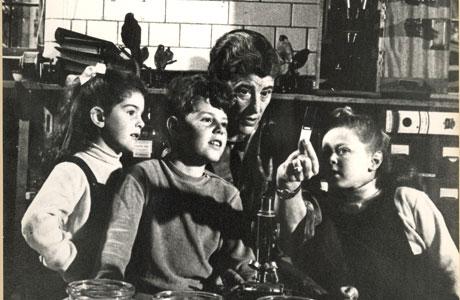 Black and white photo of Dame Miriam Rothschild DBE FRS - President of the Society (1993-94) in a lab with three children