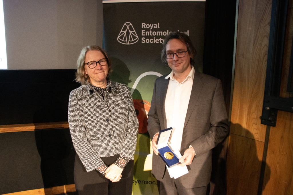 Professor Jane Hill, president of the Royal Entomological Society, awarding the 2023 Verrall Lecture speaker Dr Edgar Turner with his award.