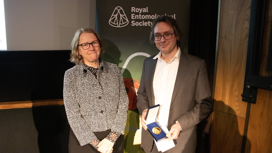 Dr Edgar Turner holding the President Medal from Professor Jane Hill, current President of RES