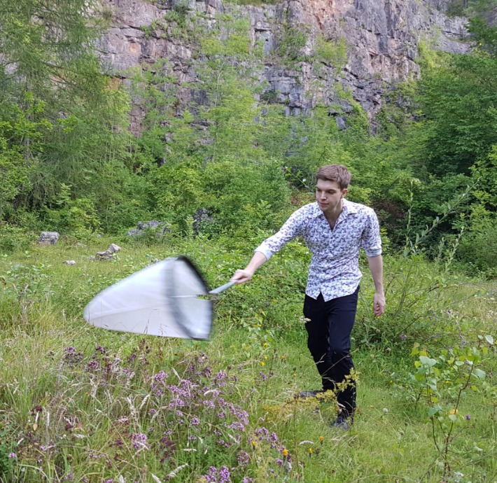 Photo of Douglas Boyes with a sweep net in a field