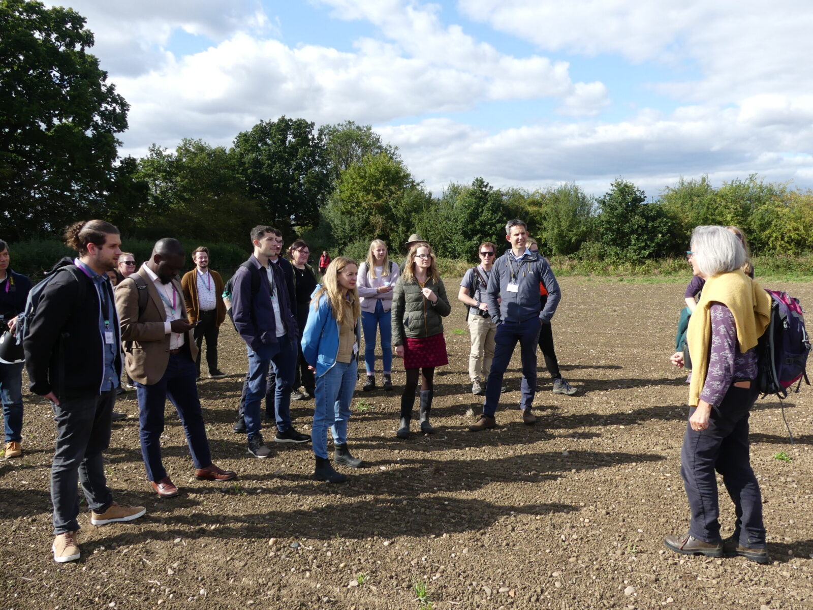Group of people in a forest clearing during an Ento22 event field trip