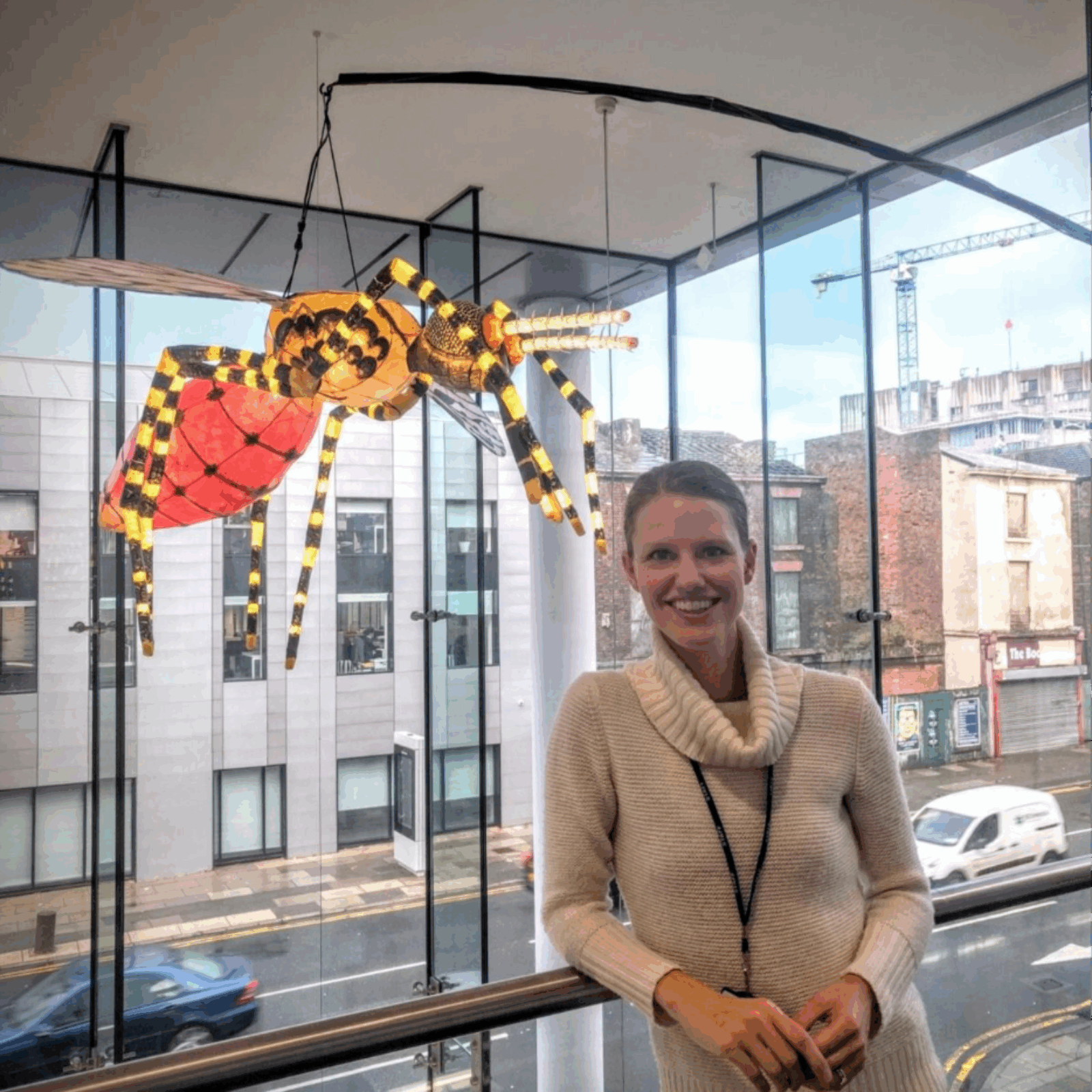Meet the Editor: Lisa Reimer with a model of an insect hovering above her