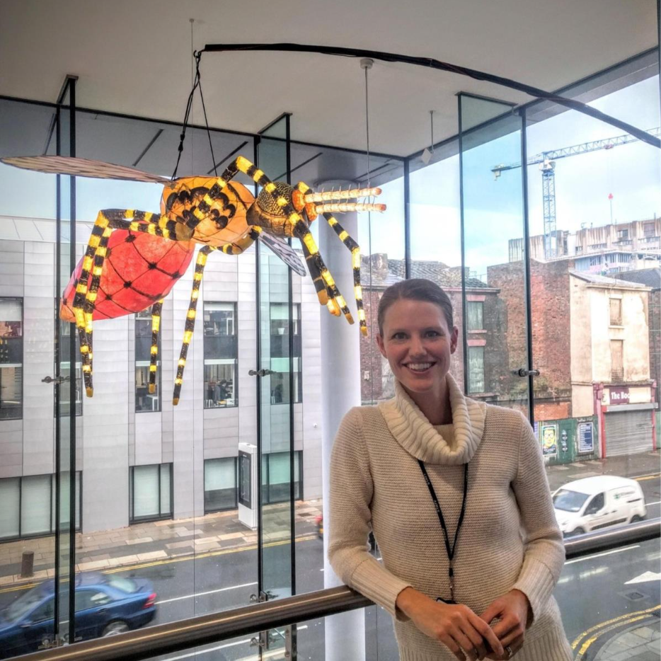 Meet the Editor: Lisa Reimer with a model of an insect hovering above her