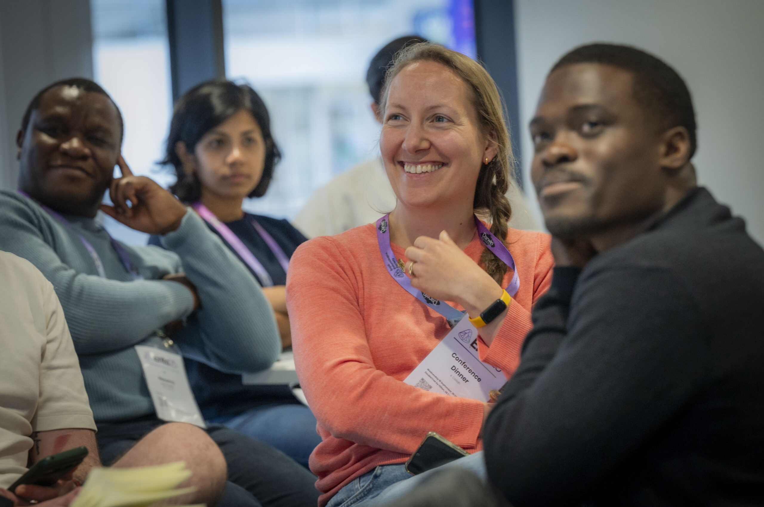 Delegates smiling in the audience at Ento25