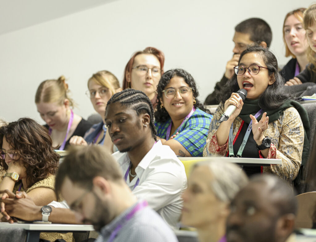 A delegate speaking and asking questions with a microphone - audience at Ento24