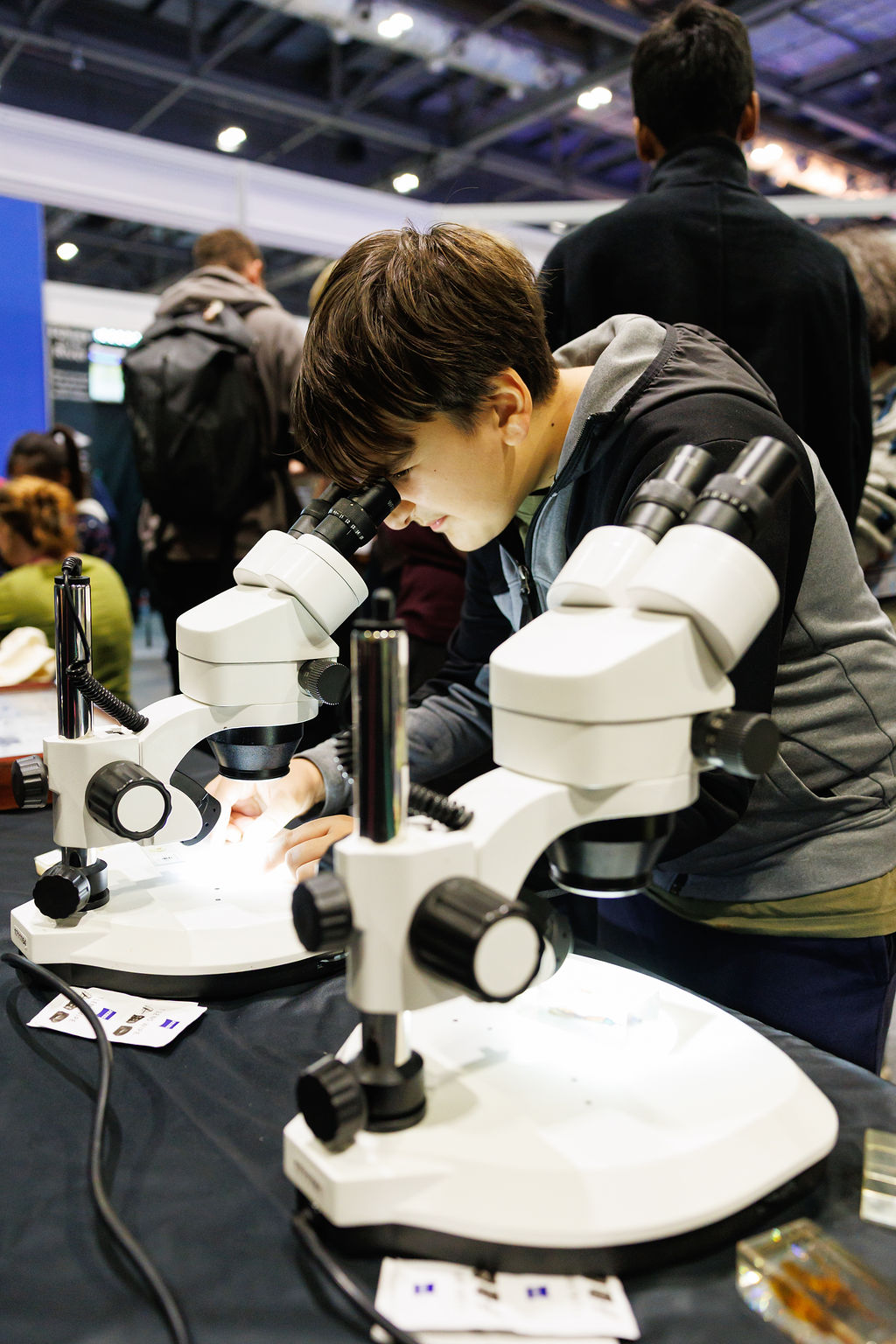 Boy looking into a microscope - photo (c) Alistair Veryard Photography - New Scientist 2025