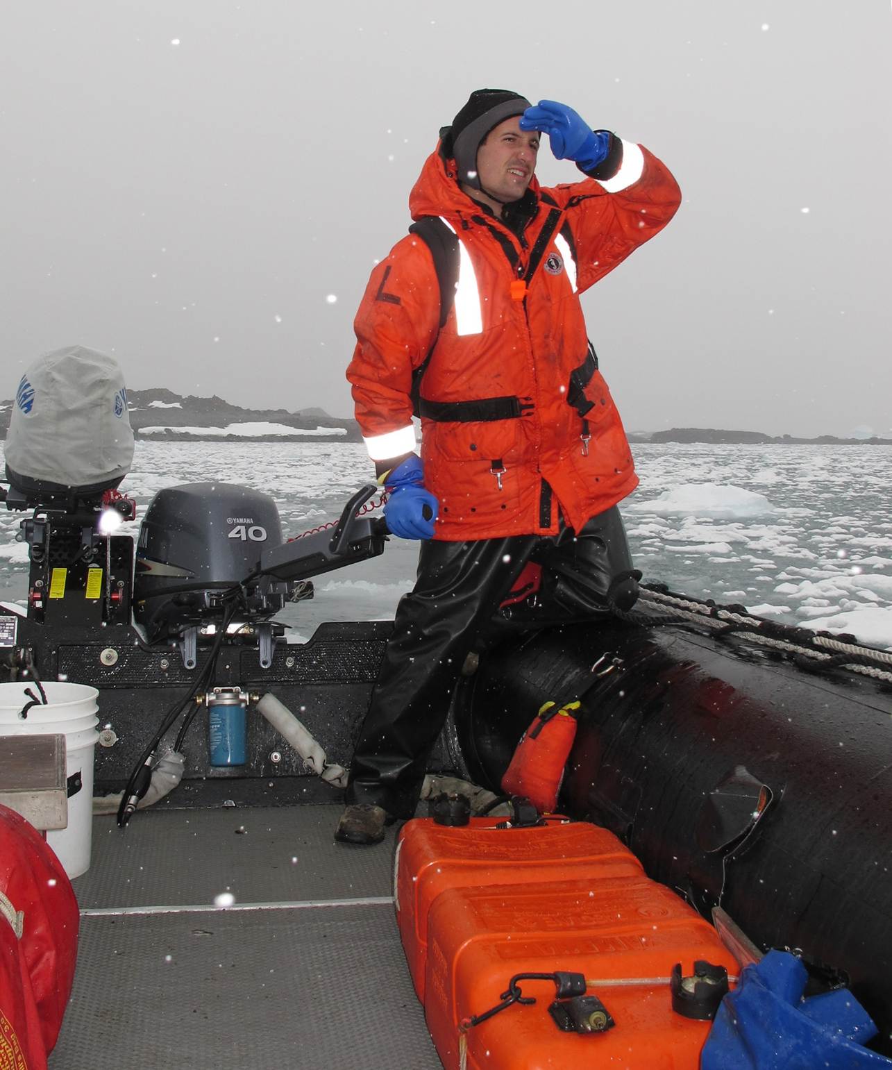 Meet the Editor: Nick Teets on a boat dressed in orange safety gear